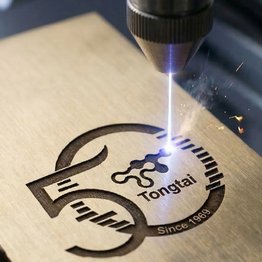 Precision laser engraving machine etching custom logos onto the surface of a metal bottle opener keychain Precision laser engraving machine etching custom logos onto the surface of a metal bottle opener keychain