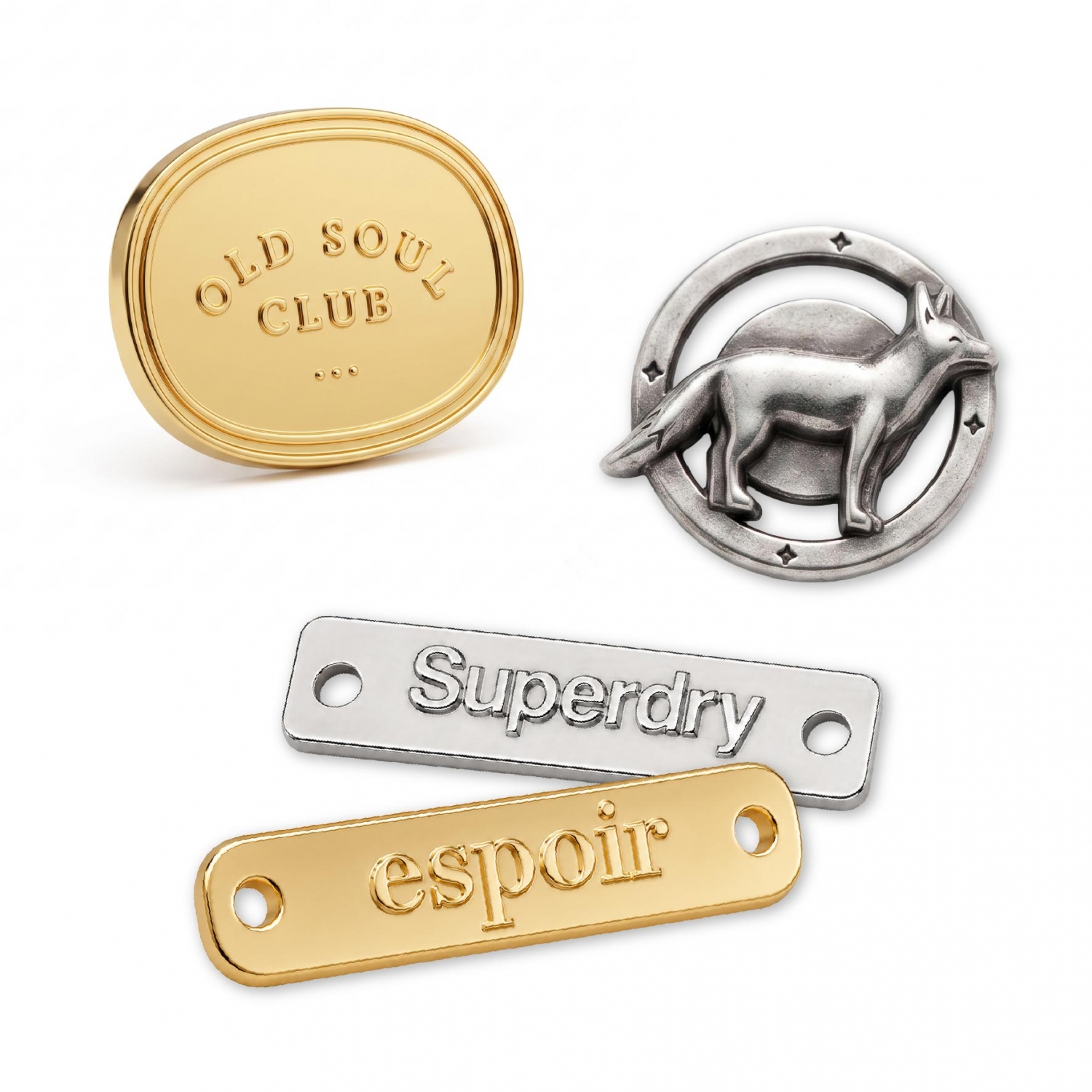 Assorted metal labels including a 3D relief animal logo, classic debossed rectangular plates, and a shiny gold oval tag