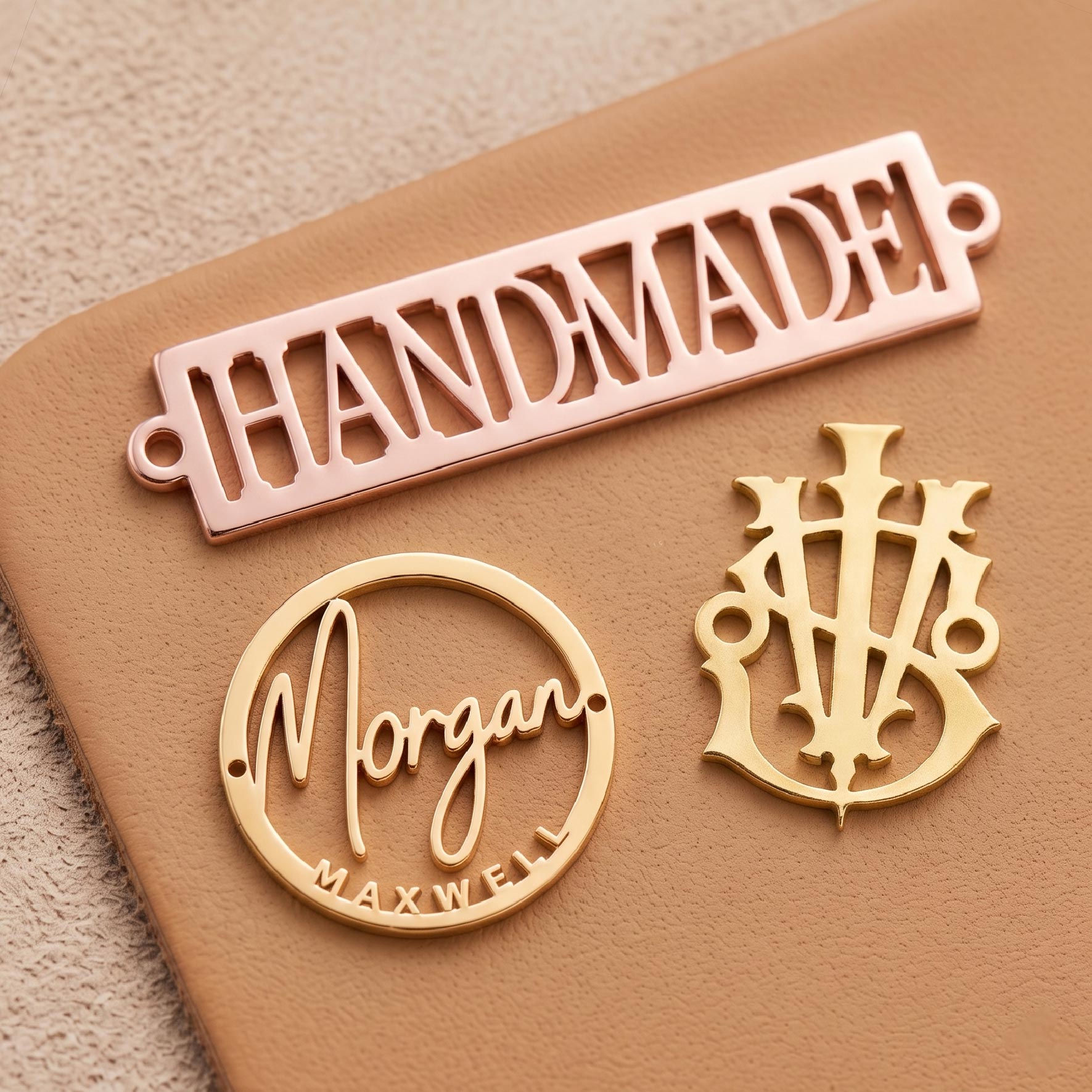 Precision cut out metal tags displaying hollowed logo designs and intricate letter shapes