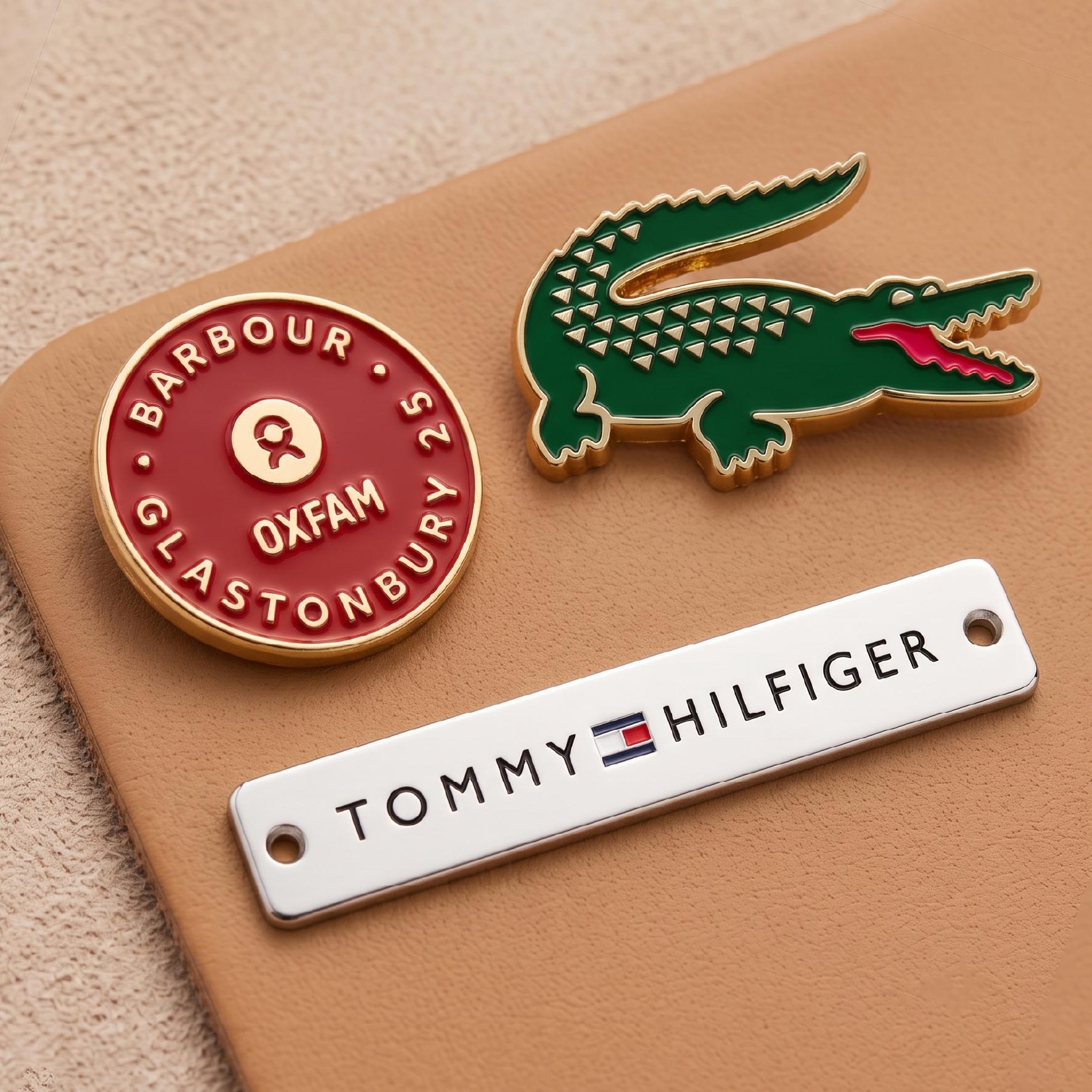 Custom metal tags featuring colorful enamel logo fill for vibrant brand presentation