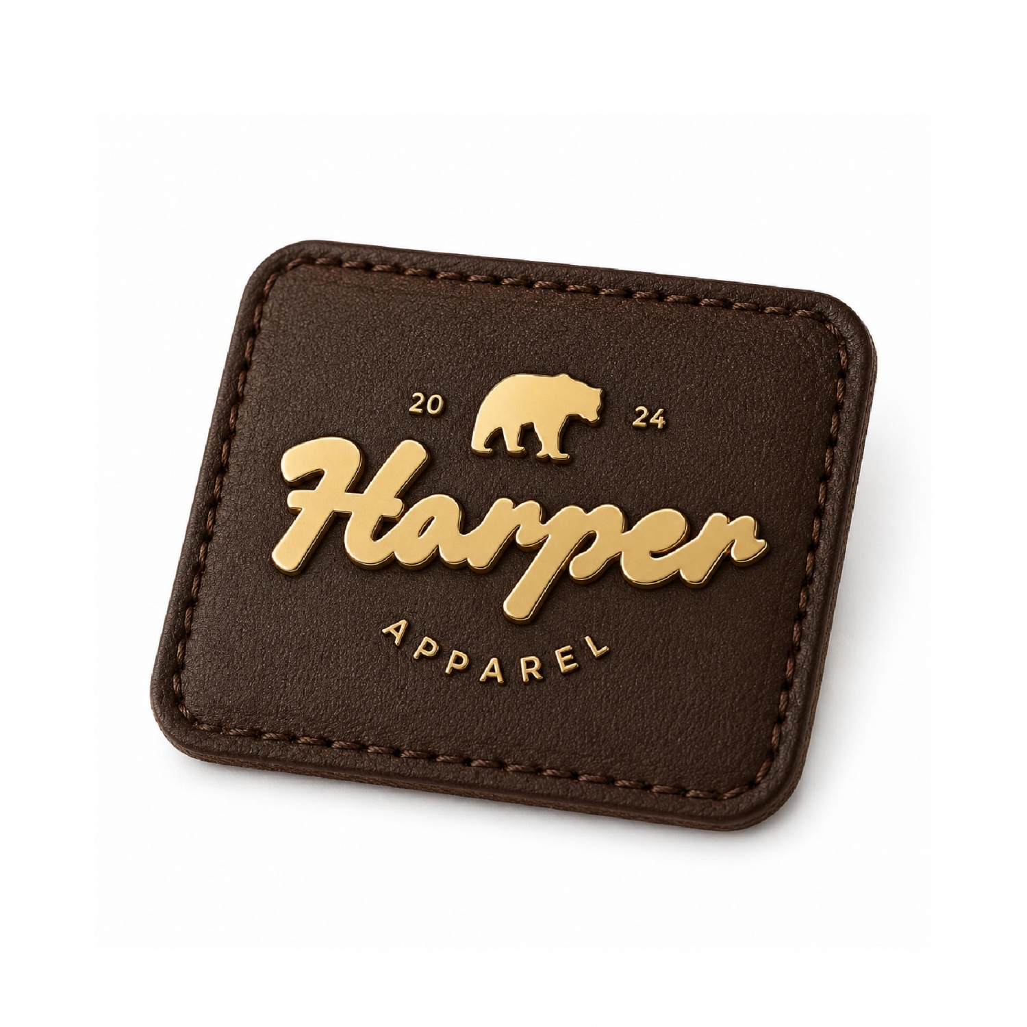 Premium custom metal logo securely attached to a square brown PU leather patch for high-end apparel