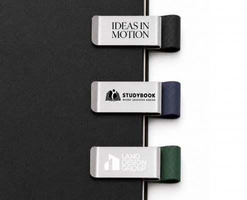 Three personalized pen clips organizing pages on a black planner