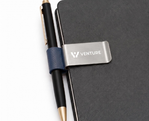 Three personalized pen clips organizing pages on a planner