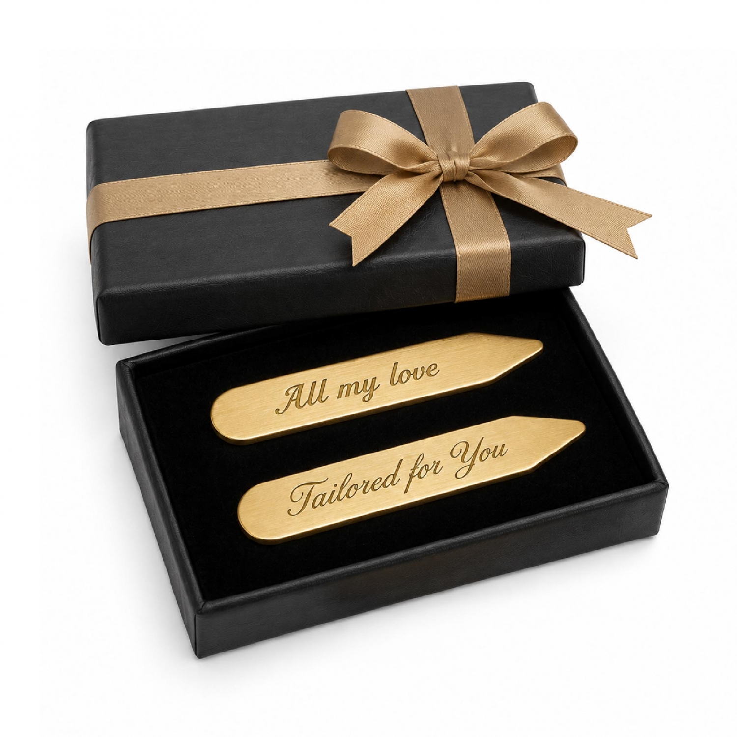 A pair of personalized brass collar stays presented in a black gift box with ribbon