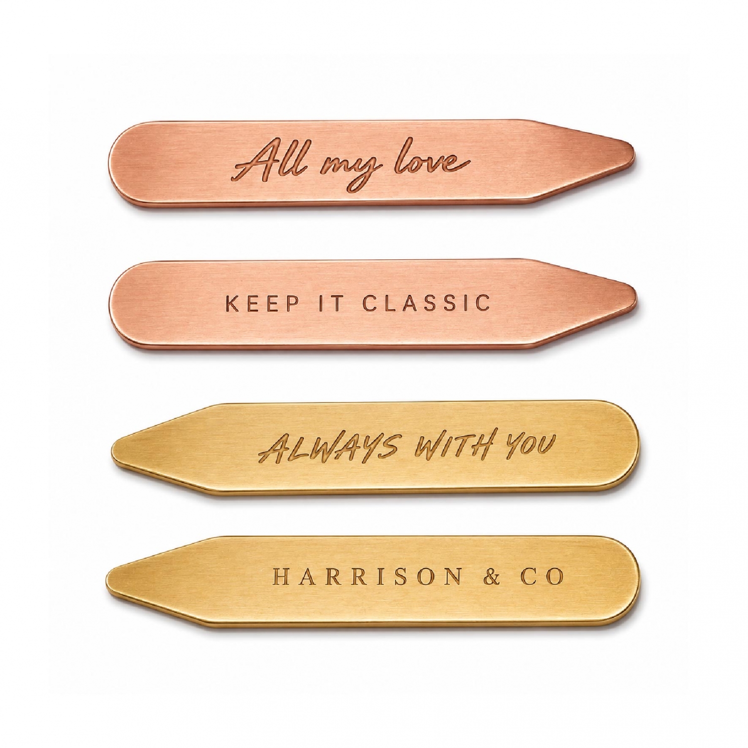 Copper and brass collar stays featuring recessed logo and text designs on brushed metal surfaces