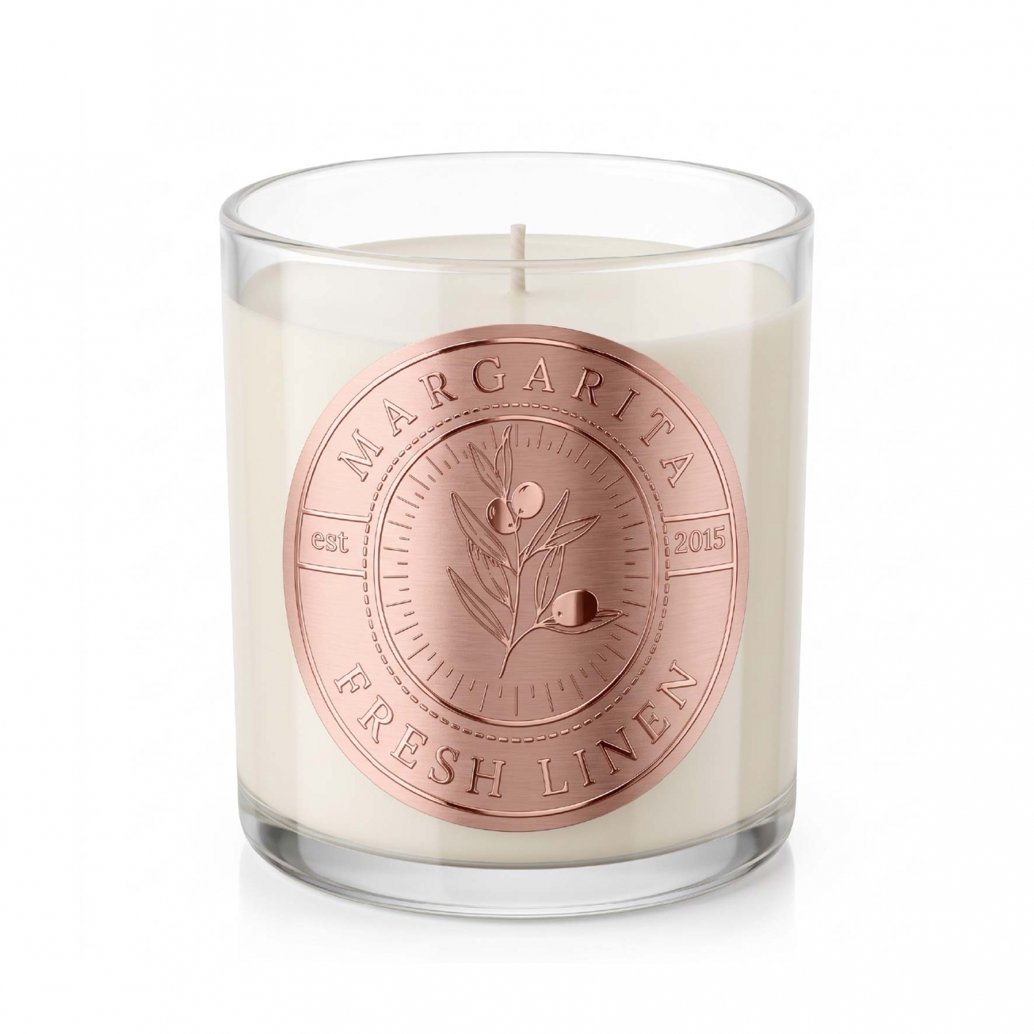 Rose gold metal label with fine graphic details applied to a glass candle jar
