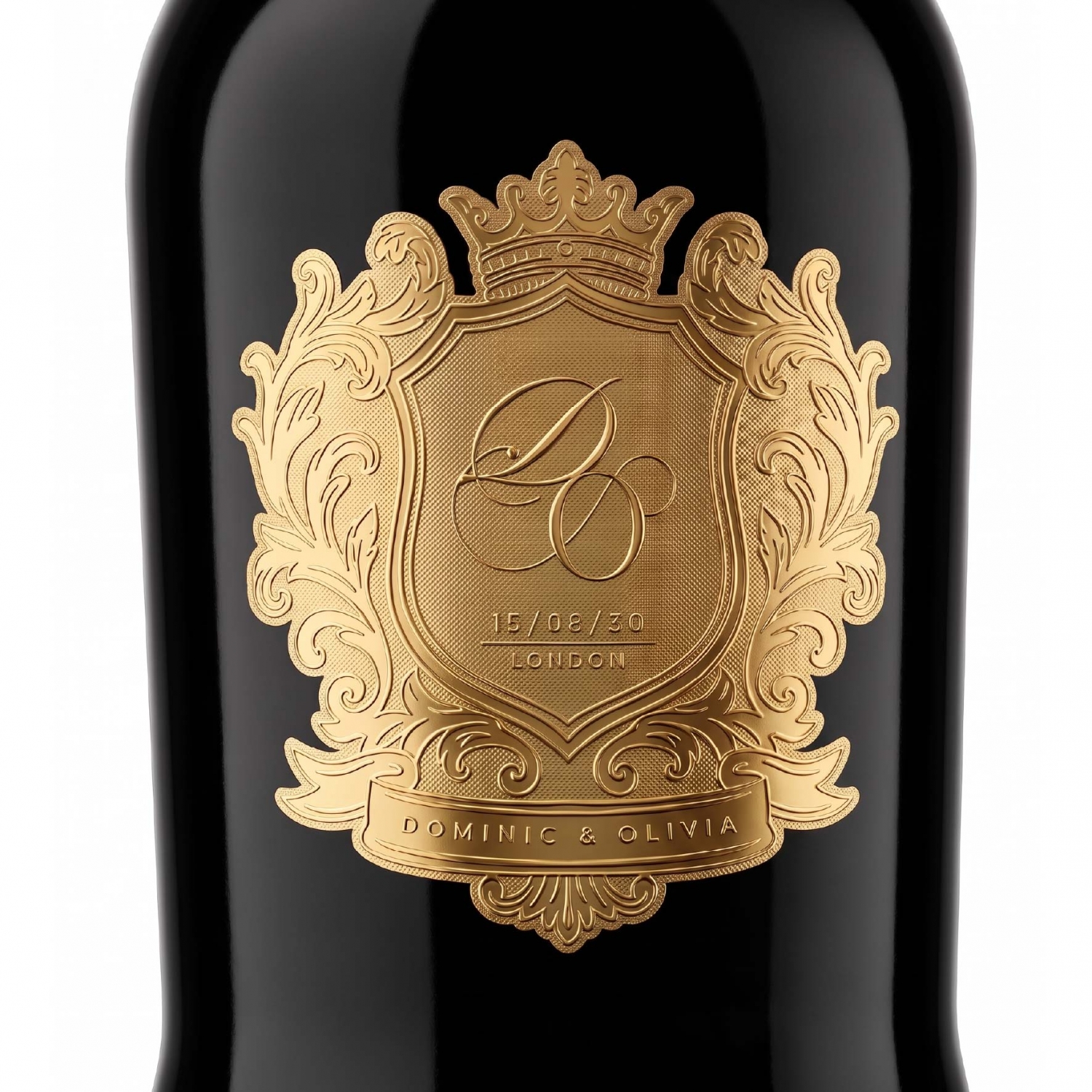 Detailed gold metal emblem with fine lines and raised decorative elements on a black bottle